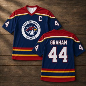 Op de afbeelding: Een marineblauw Briar University Hawks hockey-shirt met het nummer 4 op de mouwen en een groot logo op de voorkant. De trui heeft rode en gouden accenten, met de naam "GRAHAM" en nummer 44 op de rug.