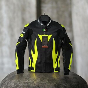 May include: Black motorcycle jacket with neon yellow flame design accents. The jacket has a stand-up collar, shoulder pads, and a front zip. The brand name "Dainese" is visible on the collar. The jacket is hanging on a black hanger.