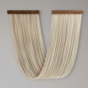 May include: A modern wall hanging featuring two wooden bars with numerous off-white cords cascading downwards. The cords are arranged to create a flowing, curved shape, adding a touch of texture and visual interest to the design.