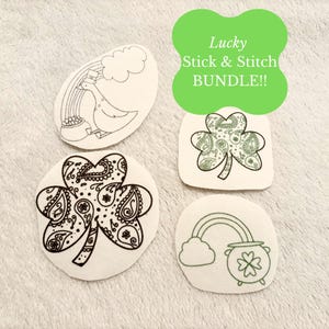 May include: A collection of four white, die-cut patches with black and green line art designs. The designs include a goose with a rainbow, two shamrocks, and a pot of gold with a rainbow. The text "Lucky Stick & Stitch BUNDLE!!" is also present.