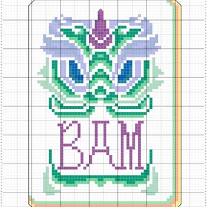 May include: Cross-stitch design featuring a symmetrical, abstract face with blue, green, and purple details. The word "BAM" is stitched in purple below the face. The design is framed with a border.