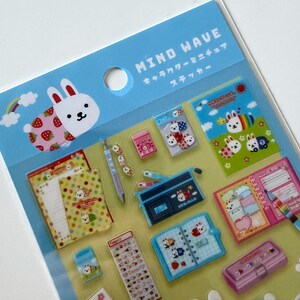 May include: A sheet of Mind Wave character stickers featuring various stationery items like notebooks, pencil cases, and pens decorated with white rabbit illustrations. The stickers are displayed on a light blue header card with Japanese text.