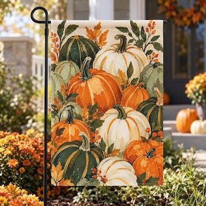 May include: A rectangular garden flag featuring a vibrant autumn-themed illustration of various pumpkins in shades of orange, white, and dark green, accented with green leaves, brown stems, and small orange berries against a light beige background.