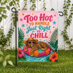 May include: A pink garden flag with the text "Too Hot to Handle, Just Right to Chill." A leopard wearing sunglasses and a straw hat floats on an inflatable ring in water. Tropical flowers and foliage surround the leopard.