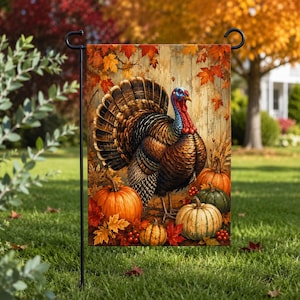 May include: A rectangular garden flag featuring a turkey standing among orange and green pumpkins, red berries, and fallen autumn leaves. The background displays a rustic wooden plank design with scattered maple leaves in shades of red and gold.