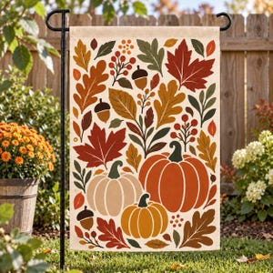 May include: A rectangular garden flag featuring a cream-colored background with a repeating autumn-themed pattern. The design includes orange and beige pumpkins, brown acorns, and various fall leaves in shades of red, orange, yellow, and dark green.