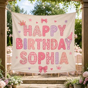 May include: A square fabric banner featuring the text HAPPY BIRTHDAY SOPHIA in large, multi-patterned pink and purple letters. The design includes decorative elements like bows, crowns, hearts, and stars scattered around the lettering.
