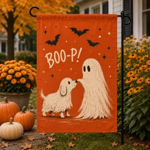 May include: A rectangular orange garden flag featuring a white illustration of a small dog and a ghost touching noses. The text BOO-P! is printed in white above the figures, accompanied by black bat silhouettes and small white star accents.