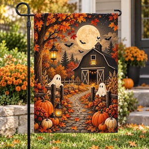 May include: A rectangular garden flag featuring a Halloween scene with a barn, a full moon, bats, and two ghosts. The landscape includes a stone path, orange pumpkins, autumn trees with red and orange leaves, and two hanging lanterns.