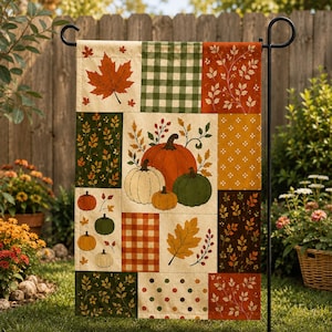 May include: A rectangular garden flag featuring a patchwork design of autumn-themed patterns including pumpkins, maple leaves, green and white gingham, orange and white plaid, and polka dots in shades of orange, green, yellow, and brown.