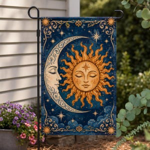 May include: A rectangular garden flag featuring a deep blue night sky background with a large, ornate crescent moon and a radiant sun, both with closed eyes and detailed facial features, surrounded by golden filigree borders and stars.