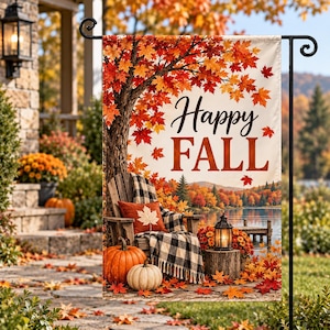 May include: A rectangular garden flag featuring a printed scene of a wooden chair with a black and white plaid blanket and a rust-colored pillow, orange pumpkins, and a lantern. The text Happy FALL is printed in black and orange script and block letters.