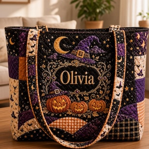 May include: A quilted tote bag featuring a black, purple, and orange Halloween-themed pattern with pumpkins, a witch hat, stars, and moons. The center displays the name Olivia in gold lettering surrounded by an ornate, decorative frame.