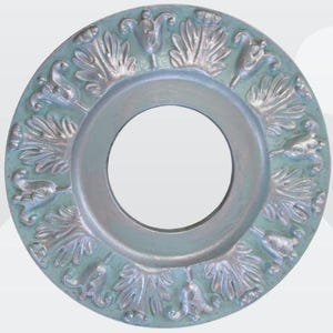 May include: A decorative ceiling medallion with a circular design. The medallion is painted in a light blue color with silver accents. The design features a repeating pattern of stylized leaves and flowers.