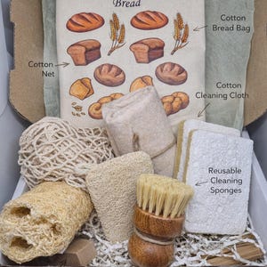 May include: A kitchen cleaning kit in a cardboard box containing a cotton bread bag with bread illustrations, a cotton net, a cotton cleaning cloth, reusable cleaning sponges, a natural loofah sponge, a loofah dish scrubber, and a wooden dish brush.
