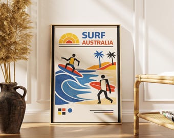 以下が含まれることがあります： 「SURF AUSTRALIA」の文字が入ったレトロなデザインの額入りポスター。サーファー、波、ビーチの風景、夕日を描いています。カラーパレットは青、オレンジ、黄色、黒です。