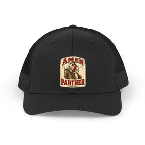 May include: Black trucker hat with a mesh back and a curved brim. The front features a rectangular patch with the words "AMEN PARTNER" and an illustration of a person on a horse. The text and illustration are in shades of brown, red, and beige.