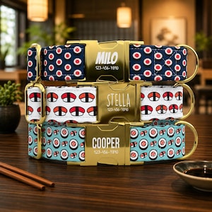 May include: Three pet collars with gold-tone metal buckles. The top collar is dark blue with sushi rolls, engraved with MILO and 123-456-7890. The middle is white with nigiri, engraved with STELLA and 123-456-7890. The bottom is light blue with sushi.