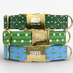 May include: Three dog collars with golf-themed patterns. The top collar is green with white golf balls and crossed golf clubs. The middle collar is green with white golf balls and stripes. The bottom collar is blue with golf course graphics. Each collar has a gold buckle with a name and phone number.