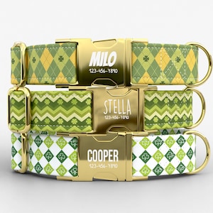 May include: Three personalized dog collars stacked on top of each other. Each collar has a gold-colored buckle with a name and phone number. The collars feature green and white patterns with shamrocks and argyle designs.