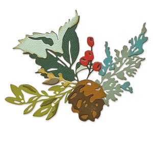 May include: A paper die-cut arrangement of a pinecone, berries, and leaves. The leaves are in shades of green, with blue and brown accents. The berries are red. Suitable for crafting or scrapbooking projects.