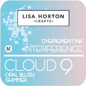 May include: A blue and pink background with white text that reads "LISA HORTON -CRAFTS- DYE/PIGMENT INK INTERFERENCE CLOUD 9 OPAL BLUSH SHIMMER" with a white "M" in the top left corner.