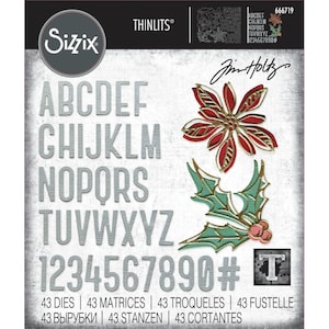 May include: Sizzix Thinlits die set featuring the alphabet, numbers, and holiday-themed shapes. The set includes a poinsettia and holly leaves with gold and red accents. The text on the packaging reads "43 Dies, 43 Matrices, 43 Troqueles, 43 Fustelle."