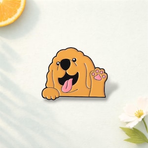 Puede incluir: Adhesivo con forma de perro golden retriever sonriendo y levantando la pata. La pata tiene una huella rosa. El perro tiene una lengua rosa. El contorno es negro. El adhesivo está sobre un fondo blanco.