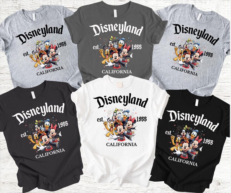 May include: A collection of t-shirts in various colors, including gray, black, and white. Each shirt features the Disneyland logo with the text "est. 1955" and a graphic of Disney characters. The word "CALIFORNIA" is also printed on the shirts.