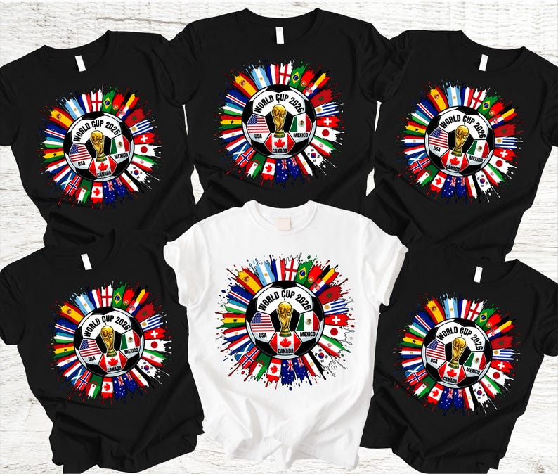 May include: A collection of black and white t-shirts featuring a soccer ball design with the text "World Cup 2026". The design includes flags of various countries and a gold trophy.