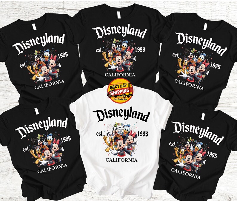 May include: Black and white t-shirts featuring the Disneyland logo with Mickey Mouse and friends. The shirts have the text "est. 1955 CALIFORNIA". One shirt is white. The image includes a "Next Day Shipping" sticker.
