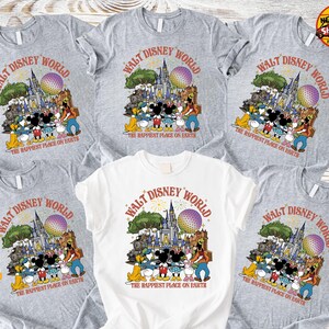 Może przedstawiać: Kilka szarych i białych koszulek z grafiką Disneya. Projekt zawiera postacie i zabytki z tekstem "WALT DISNEY WORLD" i "THE HAPPIEST PLACE ON EARTH" w stylu retro.