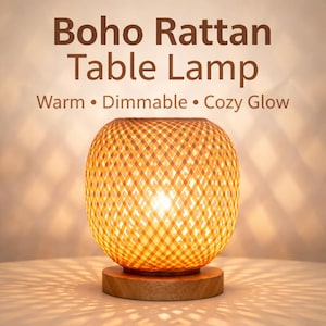 May include: A Boho Rattan Table Lamp with a warm, dimmable, cozy glow. The lamp features a woven rattan shade in a spherical shape, resting on a round wooden base. The text on the image reads: "Boho Rattan Table Lamp" and "Warm • Dimmable • Cozy Glow."