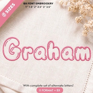 May include: An embroidery design featuring the name Graham in a pink bubble font on a white fabric background. Text includes BX FONT EMBROIDERY 1" 1.5" 2" 2.5" 3" 3.5" and With complete set of alternate letters! 11 FORMAT + BX. Includes white floral accents.