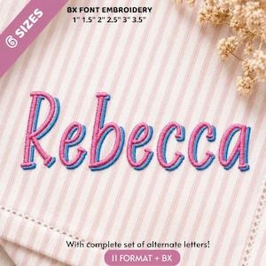 May include: The name Rebecca is embroidered in pink thread with a blue outline on a white and pink striped fabric. Text at the top reads 6 SIZES BX FONT EMBROIDERY 1" 1.5" 2" 2.5" 3" 3.5". Text at the bottom reads With complete set of alternate letters! 11 FORMAT + BX.