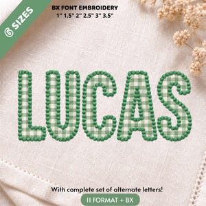 May include: The name LUCAS is embroidered in a green and white gingham pattern with a green pom-pom border. Text includes BX FONT EMBROIDERY 1" 1.5" 2" 2.5" 3" 3.5" and With complete set of alternate letters! 11 FORMAT + BX. The letters are on a textured fabric.