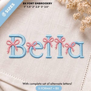 May include: Machine embroidery design featuring the name Bella in light blue thread with small pink bows attached to each letter. The text BX FONT EMBROIDERY 1" 1.5" 2" 2.5" 3" 3.5" is visible, indicating 6 sizes are available for this digital file.