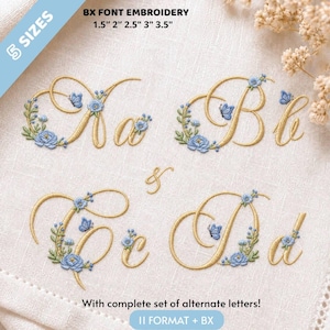 May include: Embroidery design featuring the letters A, B, C, and D in a gold cursive font, decorated with blue flowers, green leaves, and small blue butterflies. The text states 5 SIZES 3.8 cm 5.1 cm 6.4 cm 7.6 cm 8.9 cm and With complete set of alternate letters! 11 FORMAT + BX.