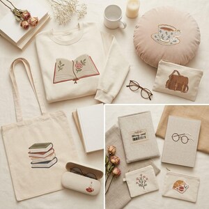 May include: A collection of cream-colored textile items including a sweatshirt with an embroidered open book, a round pillow with a teacup, a tote bag with stacked books, a glasses case, two pouches with a backpack and croissant, and two book covers.