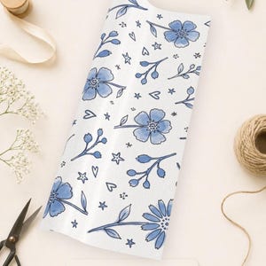Wrapping paper roll showing floral design and product format ready to cut and wrap