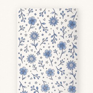 Full pattern view of floral wrapping paper with blue flowers on a soft white background