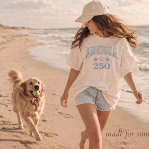 woman wearing casual patriotic shirt on beach, summer outfit america tee relaxed vintage style