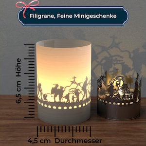 May include: Two white candle holders with intricate cut-out designs. The larger holder is 6.5 inches tall and 4.5 inches in diameter. The smaller holder is a similar design but smaller. Both holders are lit with candles, casting shadows on the wooden surface.