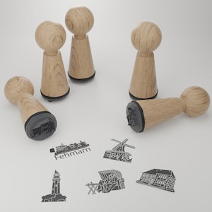 May include: Five wooden stamps with black ink pads. The stamps feature various designs, including a lighthouse, a building, a windmill, a boat, and a beach scene. The stamps are ideal for crafting and scrapbooking.