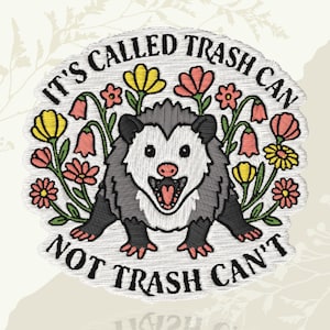 May include: Embroidered patch featuring an opossum surrounded by colorful flowers. The patch has the text "IT'S CALLED TRASH CAN NOT TRASH CAN'T" in a circular design. The opossum is gray, white, and black with a pink mouth.