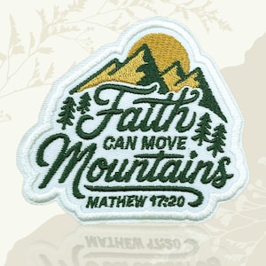 May include: Embroidered patch featuring the phrase "Faith Can Move Mountains". The design includes green mountains, pine trees, and a yellow sun. The scripture reference Matthew 17:20 is also included.
