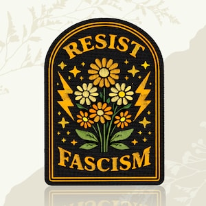 May include: Black patch with gold trim featuring embroidered flowers and lightning bolts. The text "RESIST FASCISM" is arched across the top and bottom. Stars are scattered around the floral design.