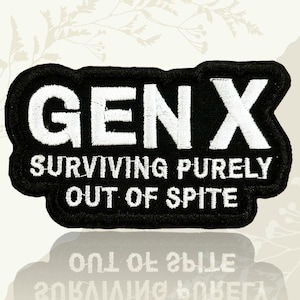 May include: Black embroidered patch with the text "GEN X SURVIVING PURELY OUT OF SPITE" in white. The patch has a black border and a reflective surface below.