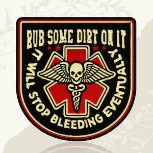 May include: Embroidered patch with a black border and a red cross design. The patch features the text "RUB SOME DIRT ON IT, IT WILL STOP BLEEDING EVENTUALLY" in a cream-colored font. A skull with wings and a medical symbol is in the center.