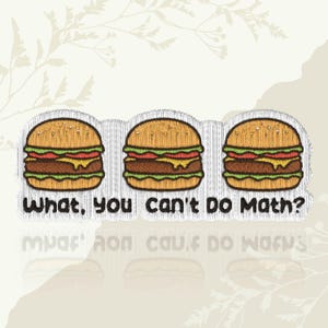 May include: Embroidered patch featuring three cartoon burgers with sesame seed buns, lettuce, tomato, cheese, and a patty. The text "What, You can't Do Math?" is below the burgers. The patch has a white background with a textured appearance.